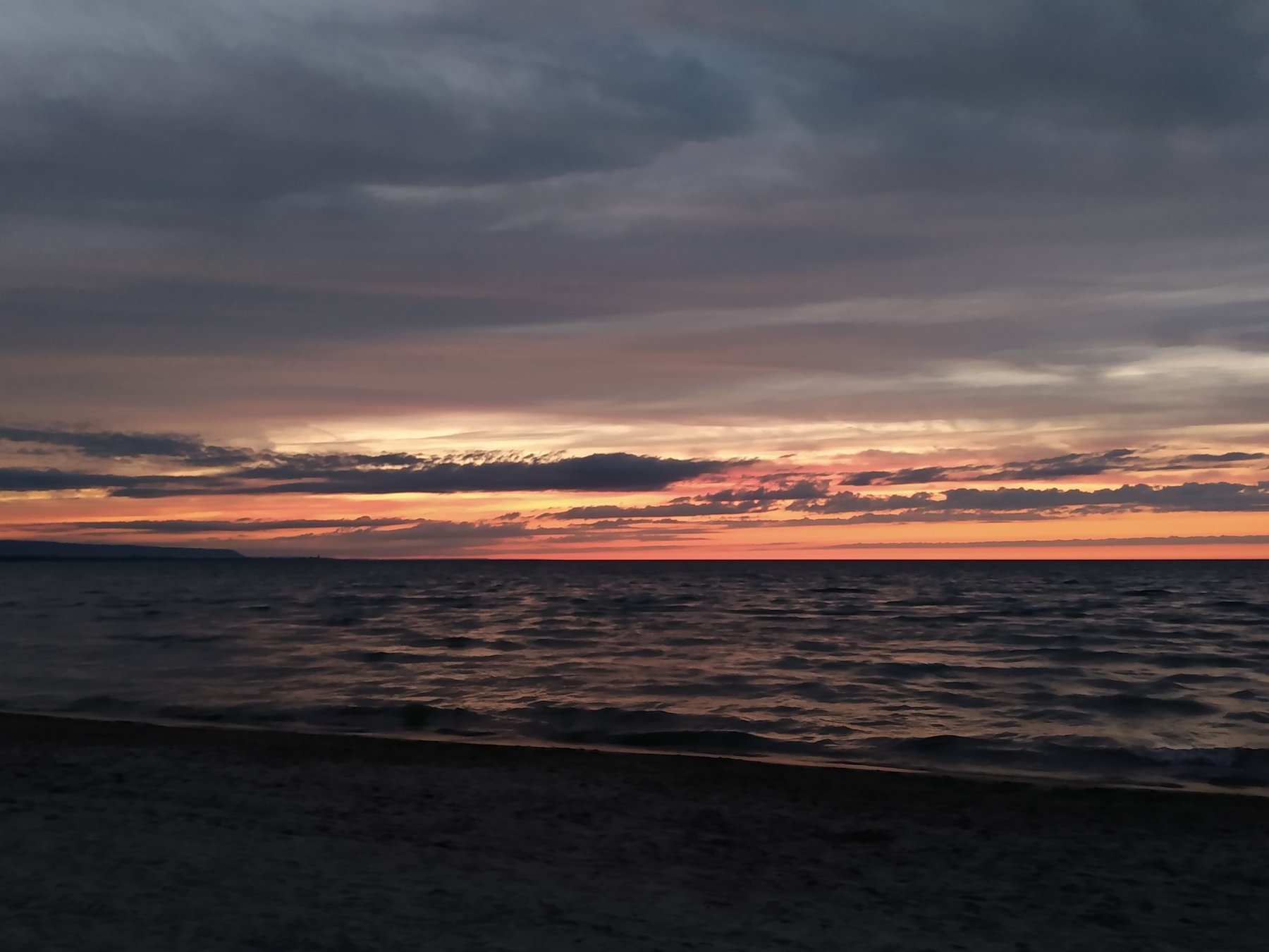 Sunset over the sand and water at Wasaga Beach, Ontario